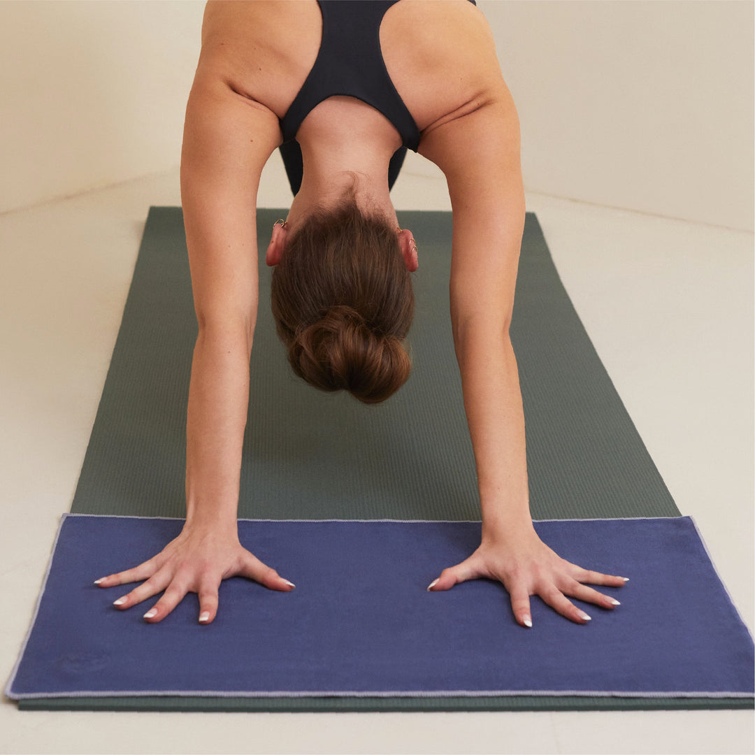 Yogi using an eQua Hand towel on her yoga mat to stop her hands slipping - Manduka | Eco Yoga Store