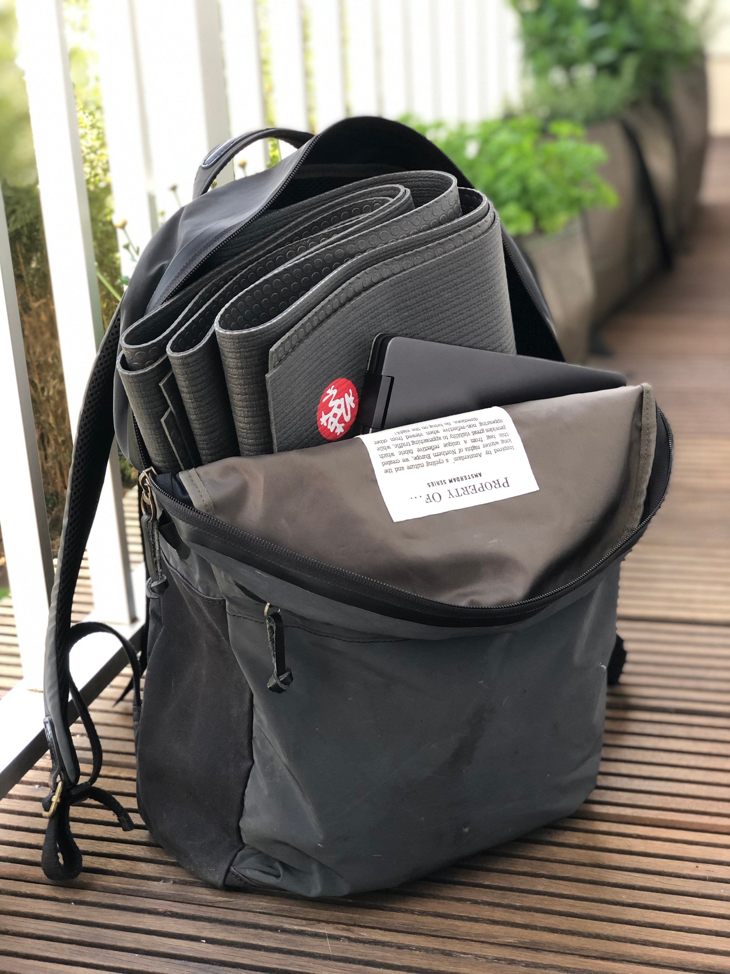 Manduka PRO Travel - Black - folded in a backpack | Eco Yoga Store