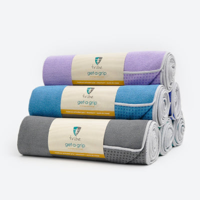 A pyramid of rolled yoga towels - Tribe | Eco Yoga Store