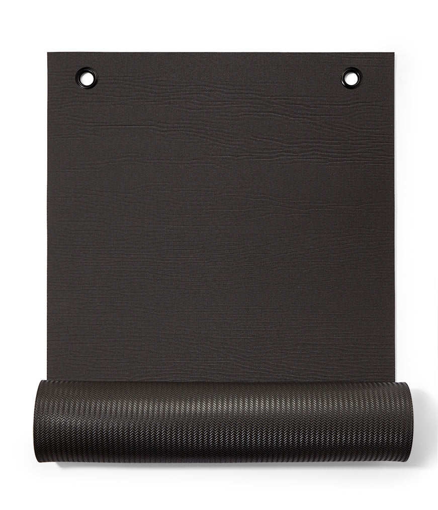 Manduka ENDURA Fitness Mat 10mm - Black - part rolled, overhead view, grommet end | Eco Yoga Store