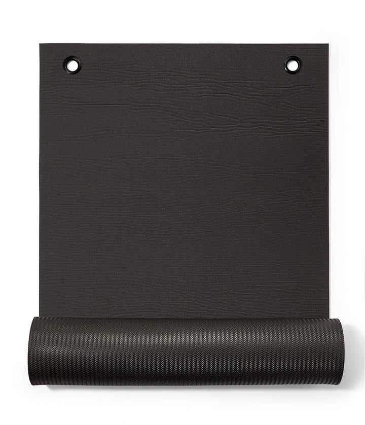Manduka ENDURA Fitness Mat 10mm - Black - part rolled, overhead view, grommet end | Eco Yoga Store