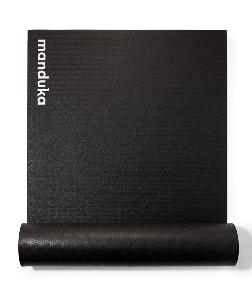Manduka P/ROX Hybrid Fitness Mat 6mm - Black - part rolled, overhead view, logo end | Eco Yoga Store