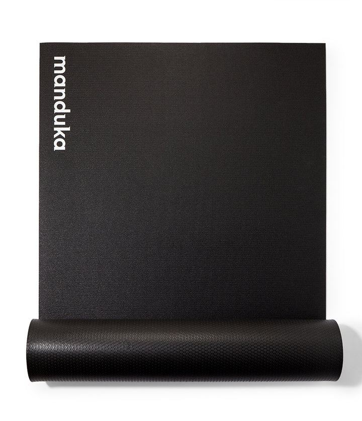 Manduka P/ROX Hybrid Fitness Mat 6mm - Black - part rolled, overhead view, logo end | Eco Yoga Store