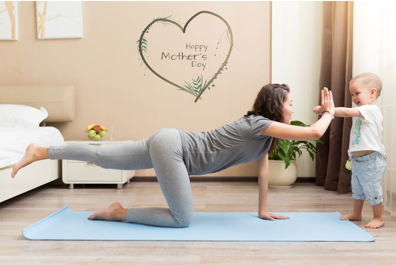 Mother on her yoga mat high fiving her toddler | Eco Yoga Store