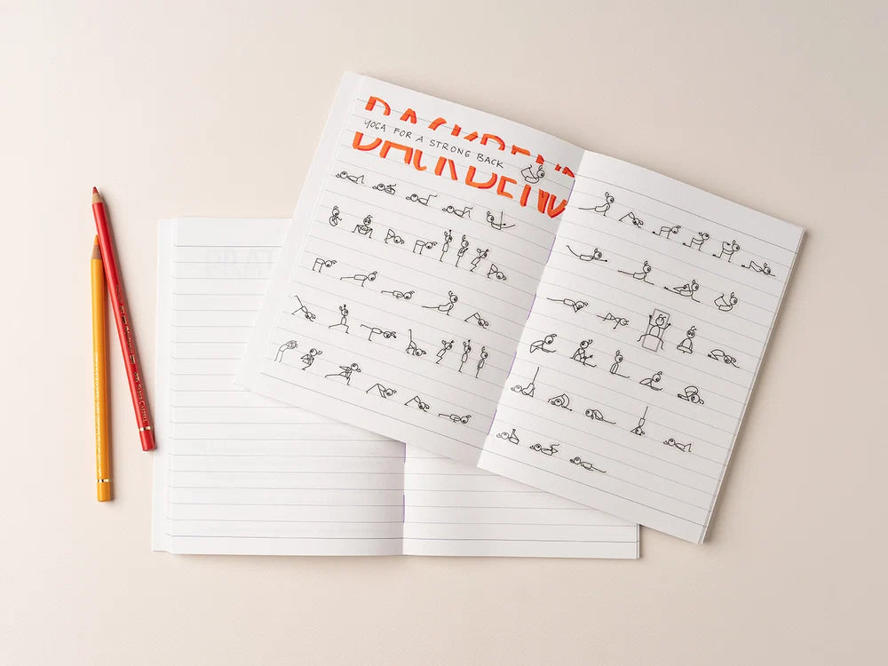 An open Yoga Journaling Notebook with handwritten notes and the word 'BACKBEND' printed in orange at the top, styled on a light beige background with two colored pencils - Yoga Journaling | Eco Yoga Store