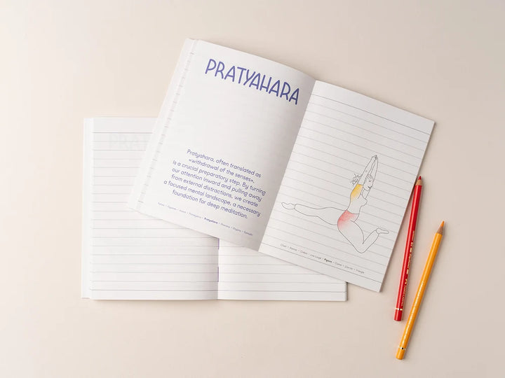 An open page of the Yoga Journaling Notebook lies on a light beige background, with the top page titled "PRATYAHARA" and a simple line drawing of a seated figure with a highlighted torso. Two colored pencils are placed to the right - Yoga Journaling | Eco Yoga Store