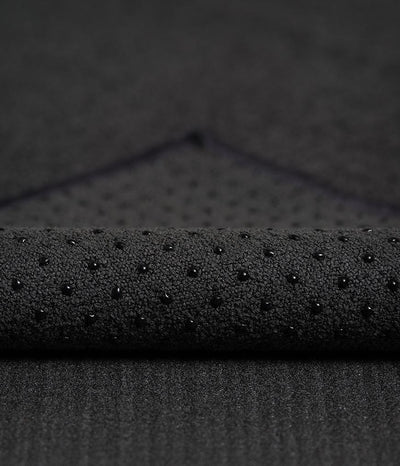 Manduka Yogitoes Mat Towel - Onyx - corner folded over showing underside | Eco Yoga Store
