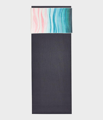Manduka eQua Hand Towel - Ebb and Flow - placed on a yoga mat | Eco Yoga Store