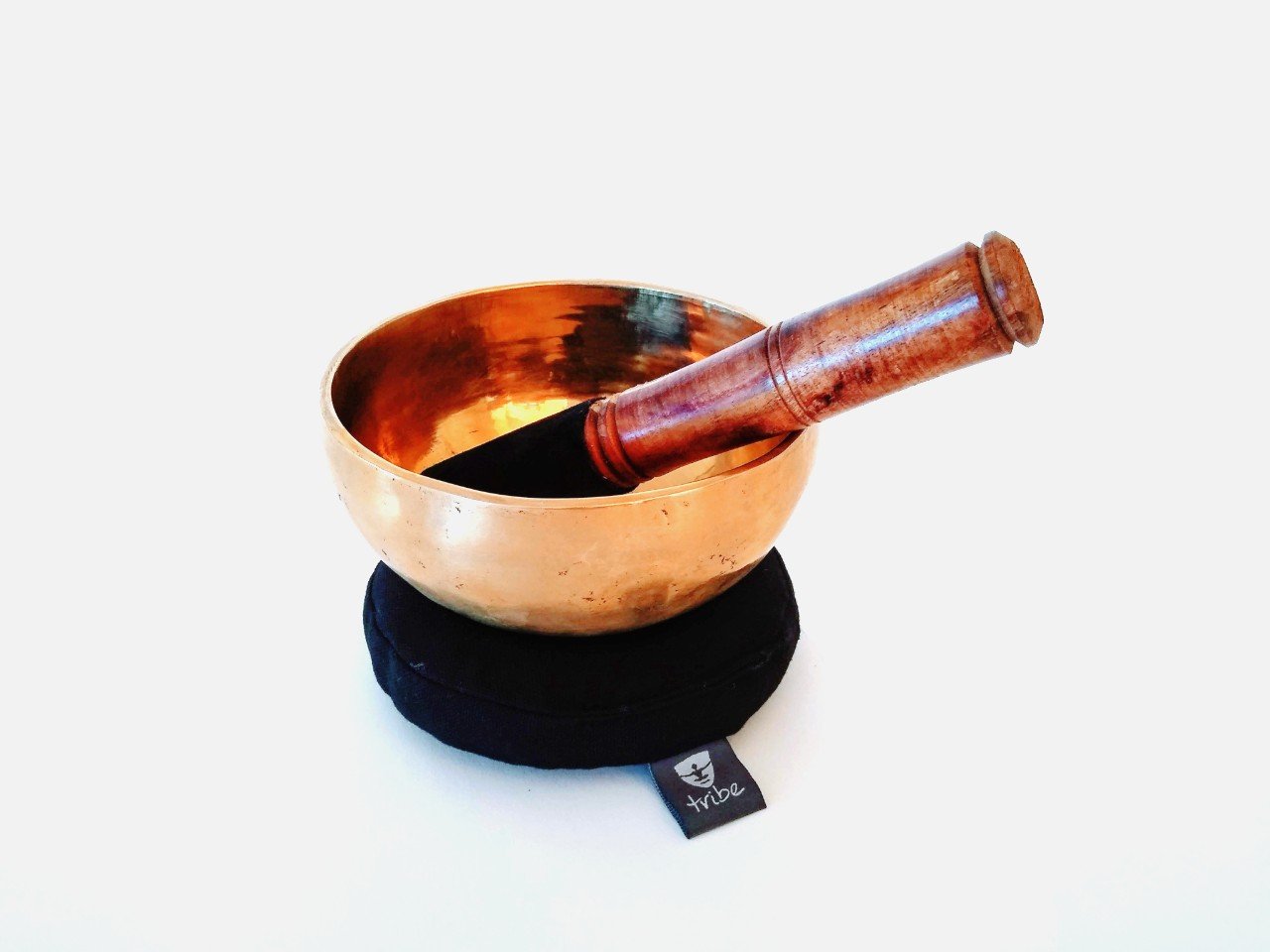 Tibetan Singing Bowl - brass bowl sitting on cotton pad with wooden striker inside bowl - TRIBE | Eco Yoga Store