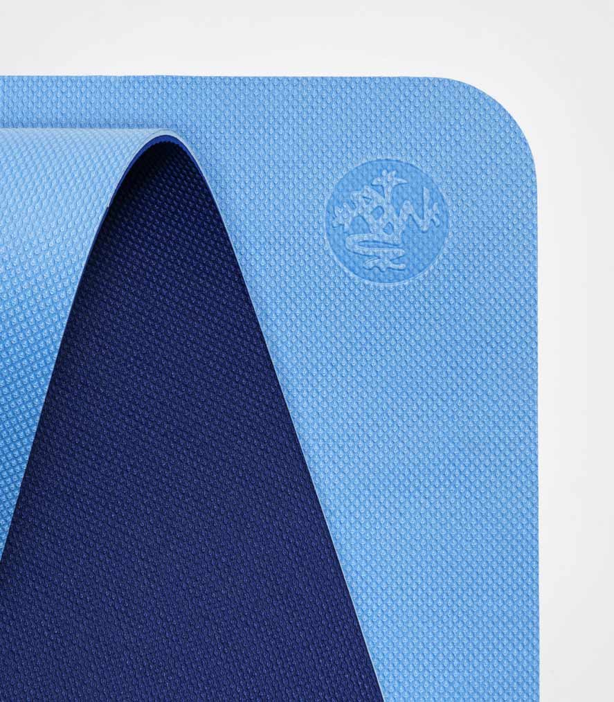 Manduka Begin Mat 5mm Yoga Mat - Light Blue - top corner loosely rolled showing both sides | Eco Yoga Store