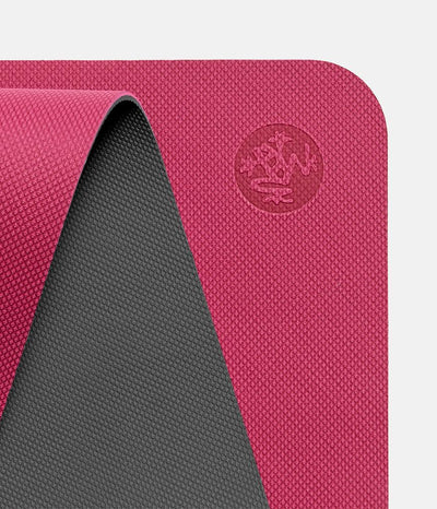Manduka Begin Mat 5mm Yoga Mat - Dark Pink - top corner loosely rolled showing both sides | Eco Yoga Store